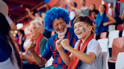 Happy boy and his grandfather cheering during sports game at the stadium. / Foto: Drazen Zigic