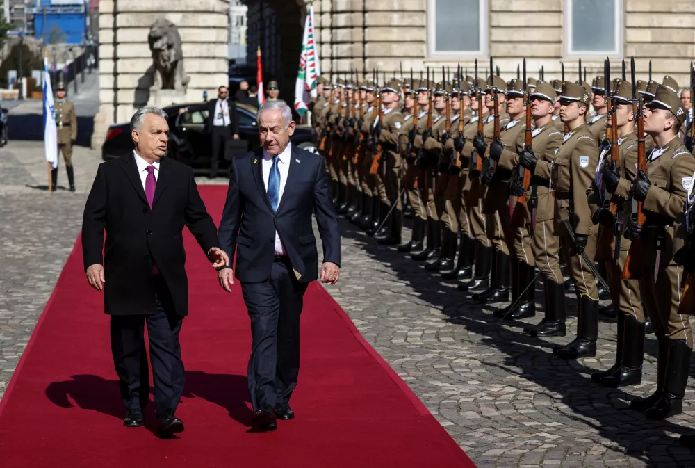 Hungarian Prime Minister Viktor Orban and Israeli Prime Minister Benjamin Netanyahu walk on the red carpet during a welcoming ceremony at the Lion's Courtyard in Budapest, Hungary, April 3, 2025. REUTERS/Bernadett Szabo