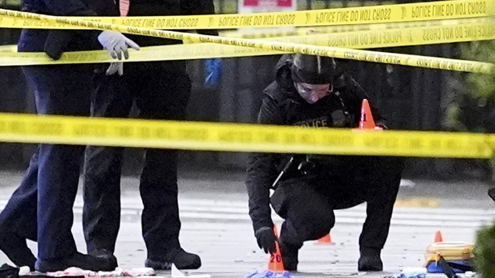 U.S. Secret Service Police place evidence markers on a crime scene after responding to reports of shots fired near the White House, Saturday, May 23, 2026, in Washington. (AP Photo/Alex Brandon)