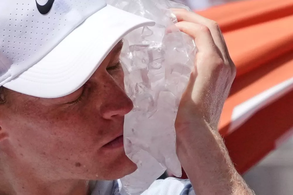 Jannik Sinner of Italy cools himself with the ice during the second round men's singles tennis match against Juan Manuel Cerundolo of Argentina at the French Open tennis tournament in Paris, Thursday, May 28, 2026. (AP Photo/Thibault Camus)