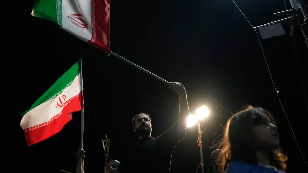 Demonstrators wave Iranian flags during a pro-government gathering at Islamic Revolution Square in Tehran, Iran, Saturday, May 30, 2026. (AP Photo/Vahid Salemi)