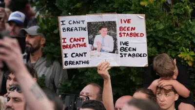 People protest outside the police station in Southampton, England, on Tuesday, June 2, 2026, one holding a photo of December 2025 stabbing victim Henry Nowak, 18. (Gareth Fuller/PA via AP)