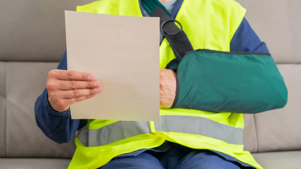 Reading letter about injury and repairman compensation paperwork, insurance, legal contract or lawyer consulting.People,attorney or advocate in negotiation, policy advice or accident report closeup