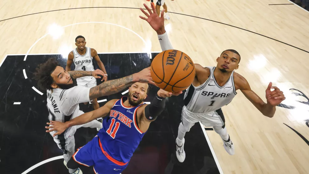 Jun 5, 2026; San Antonio, Texas, USA; New York Knicks guard Jalen Brunson (11) drives to the basket past San Antonio Spurs forward Julian Champagnie (30) and forward Victor Wembanyama (1) during game two of the 2026 NBA Finals at Frost Bank Center. Mandatory Credit: Gregory Shamus-Pool Photo via Imagn Images