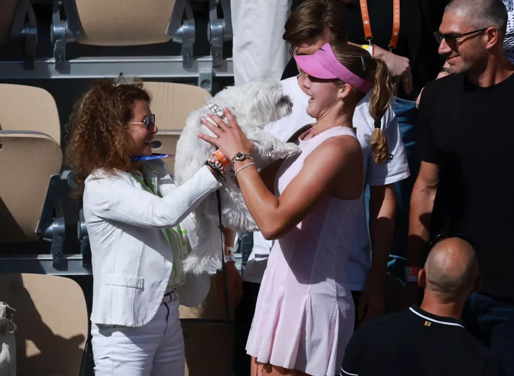 Tennis - French Open - Roland Garros, Paris, France - June 6, 2026 Russia's Mirra Andreeva celebrates with a dog after winning her final match against Poland's Maja Chwalinska REUTERS/Stephanie Lecocq