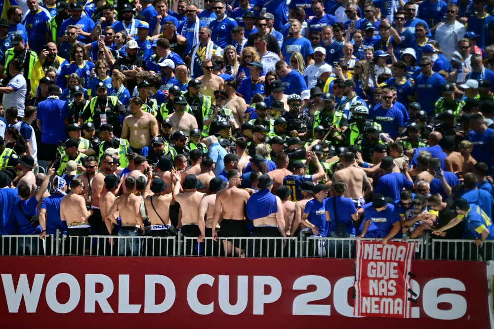 Toronto Police officers interact with Bosnia fans in the stands before the World Cup Group B soccer match between Canada and Bosnia, Friday, June 12, 2026, in Toronto. (Sammy Kogan/The Canadian Press via AP)