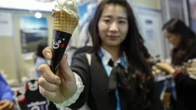 SHANGHAI, Nov. 10, 2019 A visitor shows a soy source-flavored ice cream from Japan at the Food and Agricultural Products exhibition area during the second China International Import Expo (CIIE) in Shanghai, east China, Nov. 8, 2019. The second CIIE was held from Nov. 5 to Nov. 10 at the National Exhibition and Convention Center in Shanghai.,Image: 482079668, License: Rights-managed, Restrictions:, Model Release: no 
