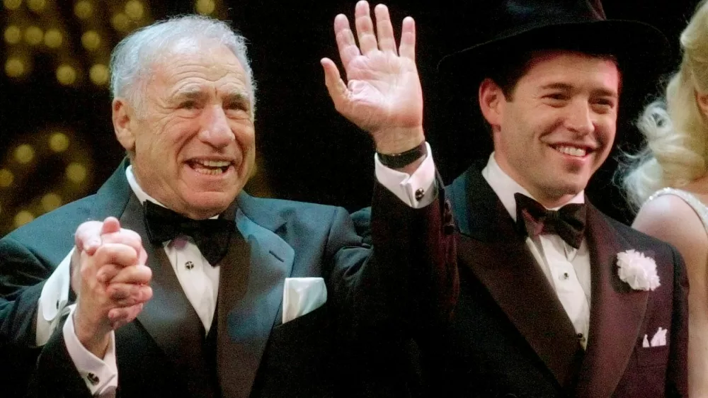 FILE - Mel Brooks, left, and Matthew Broderick react to a standing ovation at opening night of "The Producers" in New York on April 19, 2001. (AP Photo/Mark Lennihan, File)