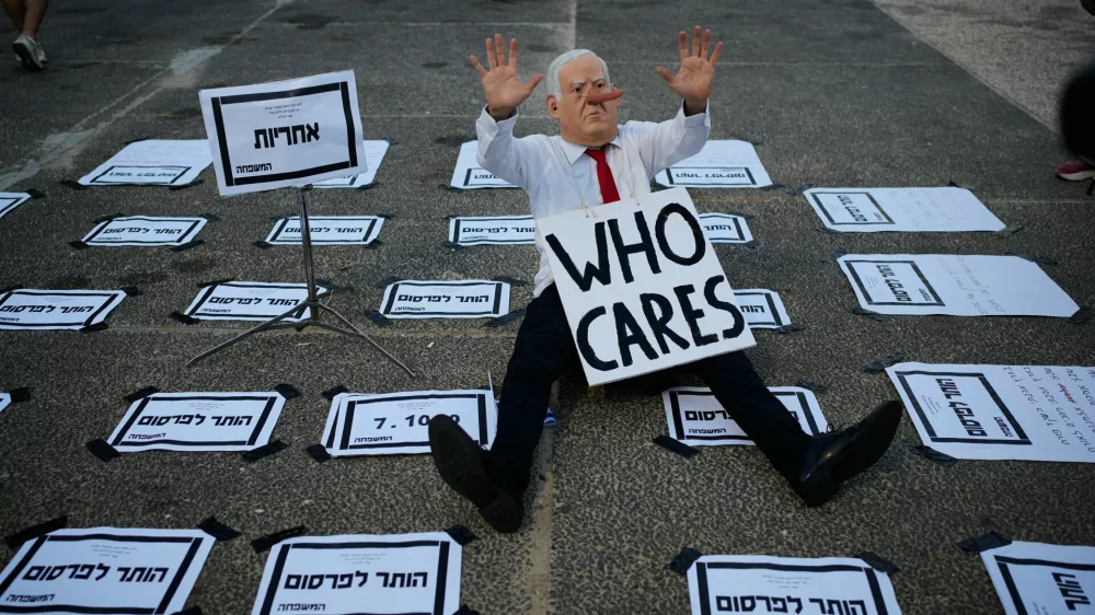 A demonstrator wears a mask depicting Israeli Prime Minister Benjamin Netanyahu during a rally marking 1,000 days to the deadly Oct. 7, 2023, Hamas-led attack on Israel, which sparked the war in Gaza, in Tel Aviv, Israel, Thursday, July 2, 2026. (AP Photo/Ohad Zwigenberg)