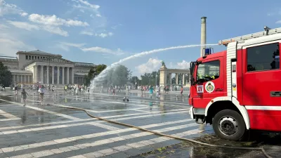 Firefighters use water cannons to spray residents at Heroes Square to help them cool off during a severe heatwave in Budapest, Hungary, June 30, 2026. Picture taken with a mobile phone. REUTERS/Krisztina Fenyo   TPX IMAGES OF THE DAY