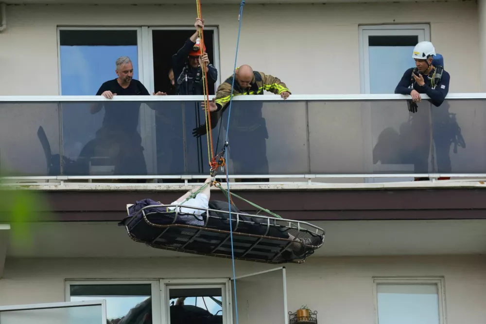 Rescuers evacuate a person at the site of a fire in an housing building in Antwerp, Belgium, July 1, 2026. REUTERS/Yves Herman