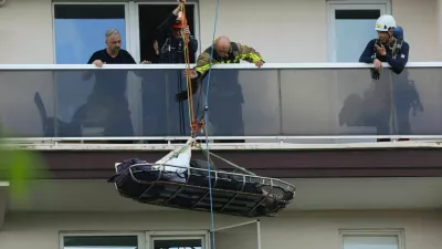 Rescuers evacuate a person at the site of a fire in an housing building in Antwerp, Belgium, July 1, 2026. REUTERS/Yves Herman