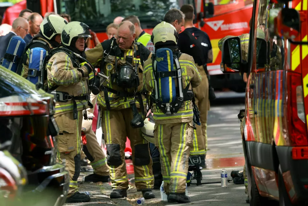 Firefighters work at the site of a fire in a housing building in Antwerp, Belgium, July 1, 2026. REUTERS/Yves Herman