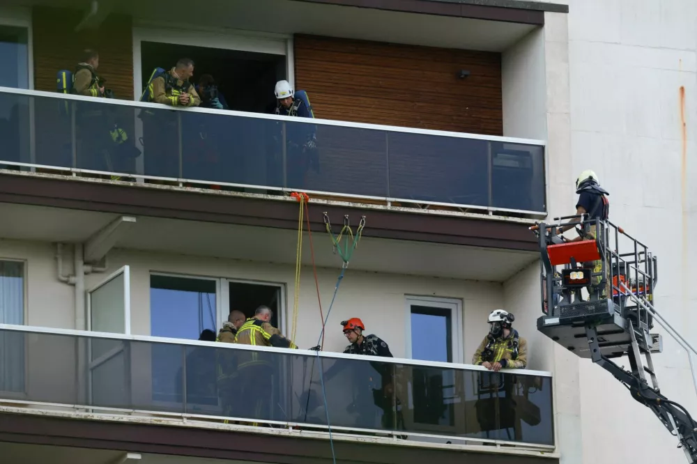 Rescuers work at the site of a fire in an housing building in Antwerp, Belgium, July 1, 2026. REUTERS/Yves Herman