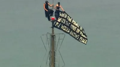 Two people display a banner atop the Empire State Building in the Manhattan borough of New York, U.S., July 1, 2026, in a still image from video. ABC Affiliate WABC via REUTERS. NO RESALES. NO ARCHIVES. THIS IMAGE HAS BEEN SUPPLIED BY A THIRD PARTY