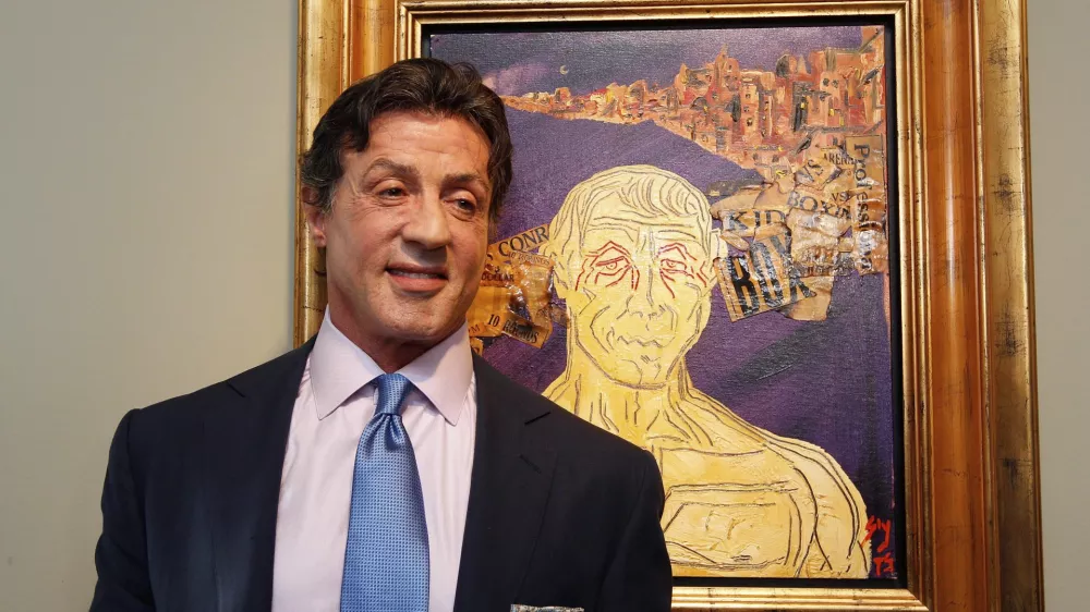 US Actor Sylvester Stallone, poses in front of one of his works during a press conference ahead of the exhibition "Sylvester Stallone. 35 Years of Painting" in the Gmurzynska gallery in St. Moritz, Switzerland, Thursday, Feb. 17, 2011. The retrospective which shows 30 pieces painted by the action star lasts from February 18 to March 15, 2011. (AP Photo/Keystone, Arno Balzarini)