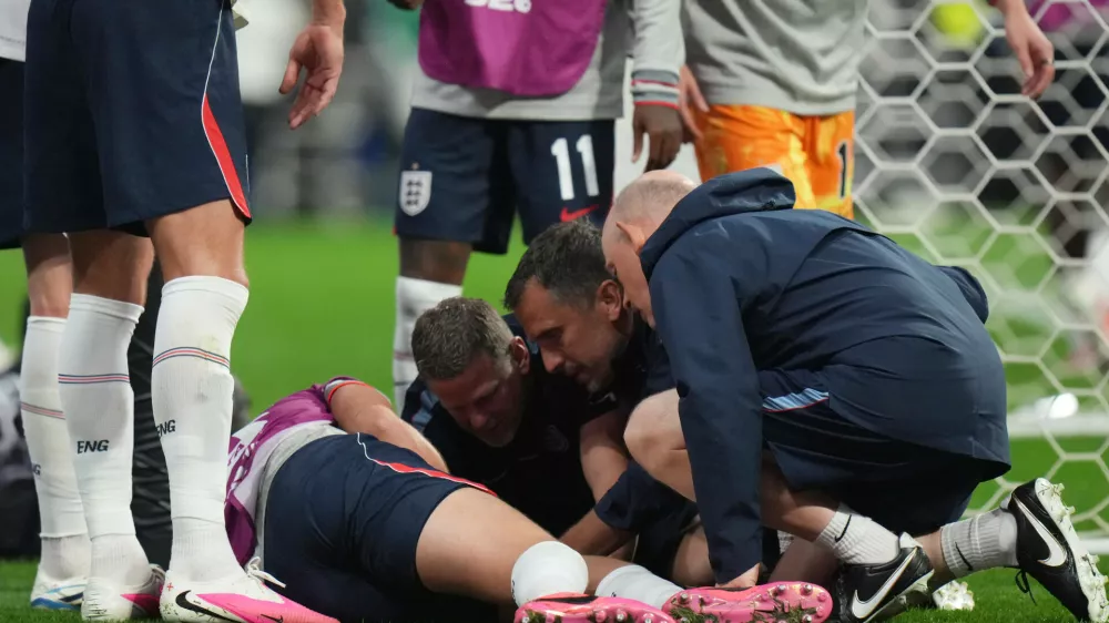 England's Jordan Henderson (14) is looked after by training staff following an injury in the postgame celebration in the World Cup round of 16 soccer match between Mexico and England in Mexico City, Sunday, July 5, 2026. (AP Photo/Eduardo Verdugo)
