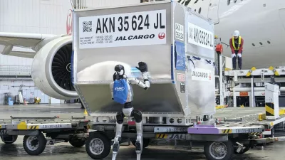 A humanoid robot pushes a cargo container during a media demonstration at Haneda airport in Tokyo on April 27, 2026. Japan Airlines will test the use of such robots at the airport from May, as the airline aims for their practical use in ground handling tasks, such as cargo loading and unloading, in 2028 amid a chronic manpower shortage.,Image: 1094715965, License: Rights-managed, Restrictions:, Model Release: no