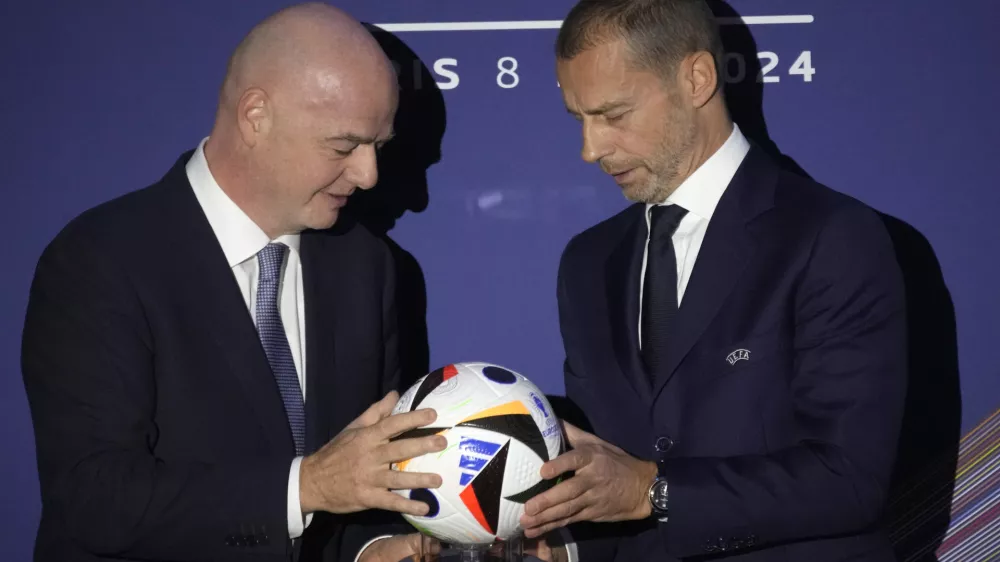 UEFA President Aleksander Ceferin, right, and FIFA President Gianni Infantino pose during the 48th UEFA congress in Paris, Thursday, Feb. 8, 2024. (AP Photo/Christophe Ena)