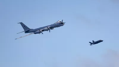 Royal Navy F-35B fighter, right, of UK Carrier Strike Group launches from HMS Prince of Wales to intercept a Russian military aircraft, Thursday July 2, 2026. (Chris Sellars/Ministry of Defence via AP)