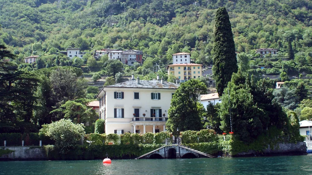 ** FILE ** A lakeside view of George Clooney's villa Oleandra in Laglio, on Lake Como, northern Italy, on July 8, 2004. U.S. film star George Clooney has joined a protest to stop construction of parking lots and a promenade in the northern Italian lakeside town where he owns a villa because he fears his presence is turning the quiet town into a tourist attraction, Friday, July 22, 2007.. (AP Photo/Antonio Calanni, files)