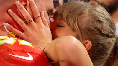 FILE PHOTO: Football - NFL - Super Bowl LVIII - Kansas City Chiefs v San Francisco 49ers - Allegiant Stadium, Las Vegas, Nevada, United States - February 11, 2024 Kansas City Chiefs' Travis Kelce kisses partner Taylor Swift as they celebrate after Kansas City Chiefs win Super Bowl LVIII REUTERS/Brian Snyder/File Photo