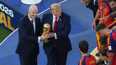 FIFA President Gianni Infantino and President Donald J. Trump present the trophy to Spain's Rodri (16) after the World Cup final soccer match between Spain and Argentina in East Rutherford, N.J., near New York, Sunday, July 19, 2026. (AP Photo/Matt Rourke)