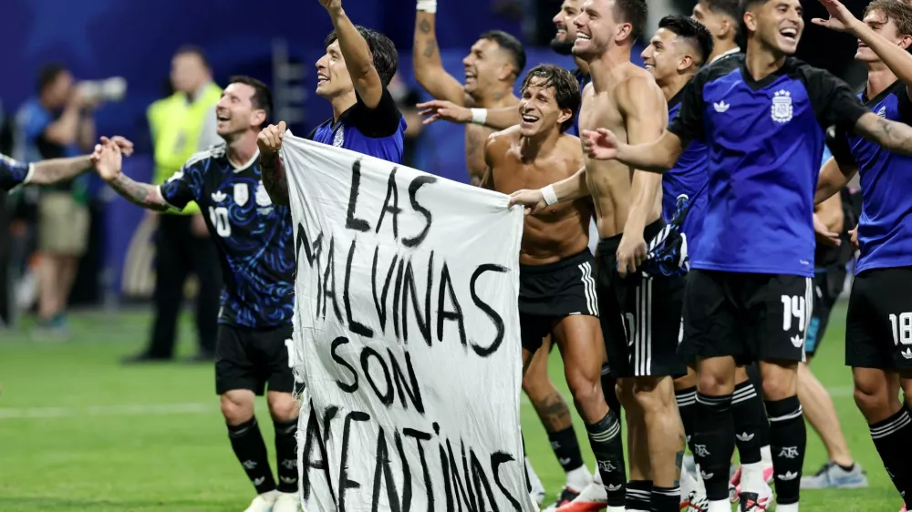 Soccer Football - FIFA World Cup 2026 - Semi Final - England v Argentina - Atlanta Stadium, Atlanta, Georgia, U.S. - July 15, 2026 Argentina's Lisandro Martinez and Giovani Lo Celso celebrate with a Falkland Islands related banner after the match as Argentina qualify for the final of the World Cup REUTERS/Amanda Perobelli   TPX IMAGES OF THE DAY
