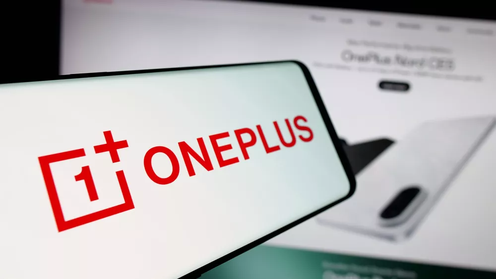 In this photo illustration, a smartphone with the logo of company OnePlus Technology (Shenzhen) Co. Ltd is seen on screen in front of website.