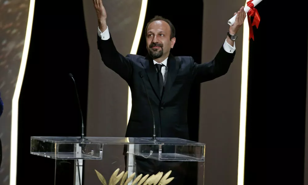 Director Asghar Farhadi, Best screenplay award winner for his film "Forushande" (The Salesman), reacts on stage during the closing ceremony of the 69th Cannes Film Festival in Cannes, France, May 22, 2016.      REUTERS/Eric Gaillard