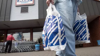 FILE - In this July 30, 2002 file photo a man carries two plastic bags in front of an ALDI market in Gelsenkirchen, Germany. German discount supermarket chain Aldi says Wednesday, July 28, 2010, Theo Albrecht, its co-founder and considered one of the country's richest men, has died. He was 88. (AP Photo / Martin Meissner, file)