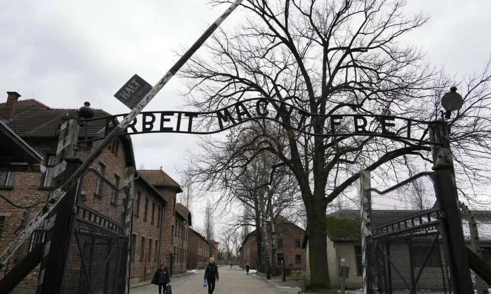 People visit the Memorial and Museum Auschwitz-Birkenau, a former Nazi German concentration and extermination camp, in Oswiecim, Poland, Sunday, Jan. 26, 2025. (AP Photo/Czarek Sokolowski)