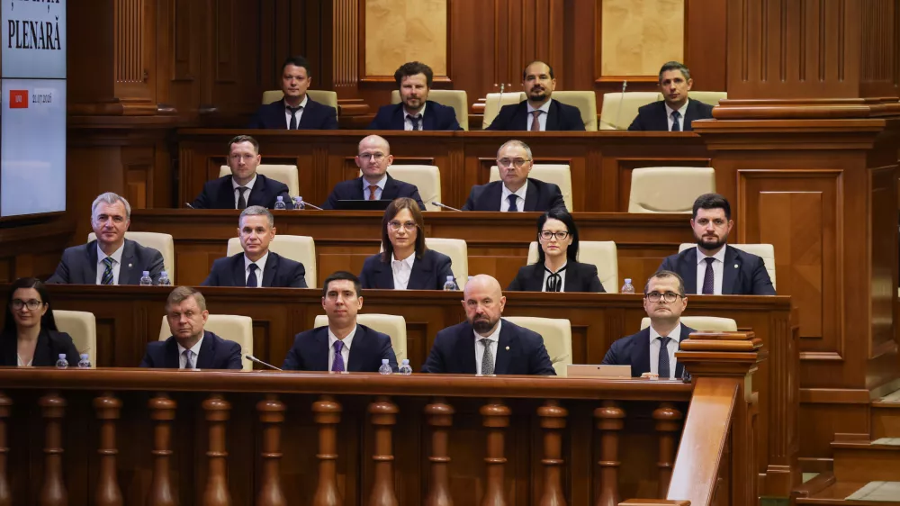 Prime Minister designate Vasile Tofan, right, on the bottom row, sits with his government team before the parliament's confidence vote in Chisinau, Moldova, Tuesday, July 21, 2026. (AP Photo/Aurel Obreja)
