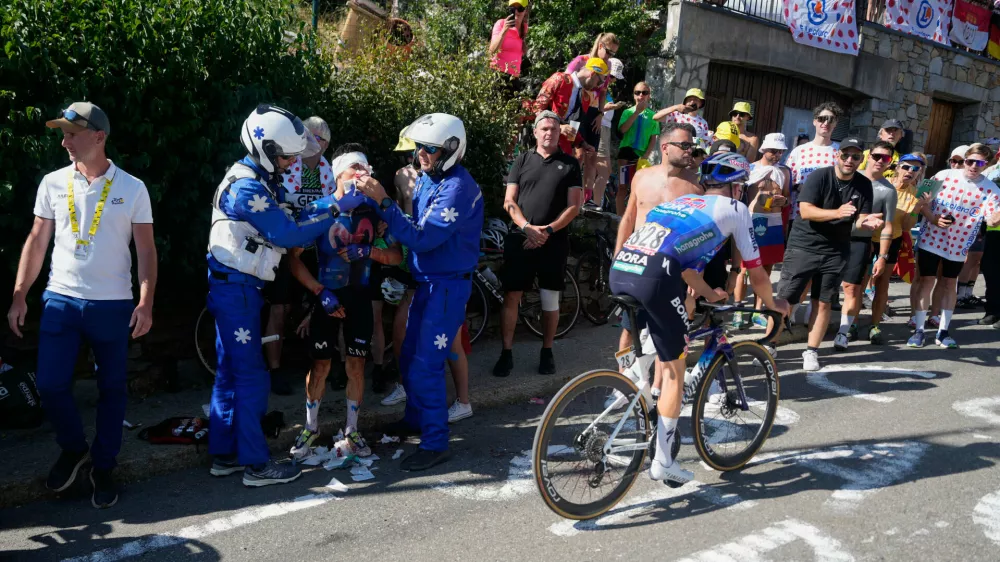 Colombia's Einer Rubio receives medical attention during the nineteenth stage of the Tour de France cycling race with start in Gap and finish in Alpe d'Huez, France, Friday, July 24, 2026. (AP Photo/Mosa'ab Elshamy)