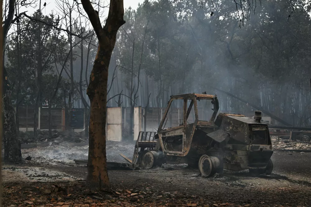 A view of a burned tractor in Lanton, in the Lege-Cap-Ferret region, southwestern France, Saturday, July 25, 2026. (AP Photo/Emma Da Silva)