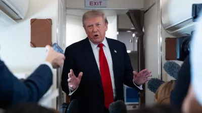 President Donald Trump speaks with reporters while on Air Force One en route to Oakland County International Airport, Monday, July 27, 2026, in Waterford Township, Mich. (AP Photo/Alex Brandon)