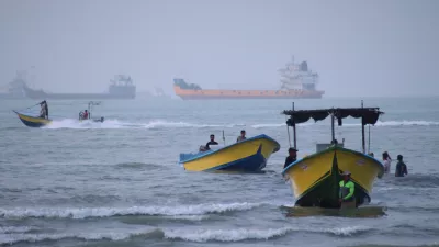 Small boats line the shore as cargo ships and other commercial vessels appear anchored in the Strait of Hormuz off Bandar Abbas, Iran, Monday, July 27, 2026. (Razieh Poudat/ISNA via AP)
