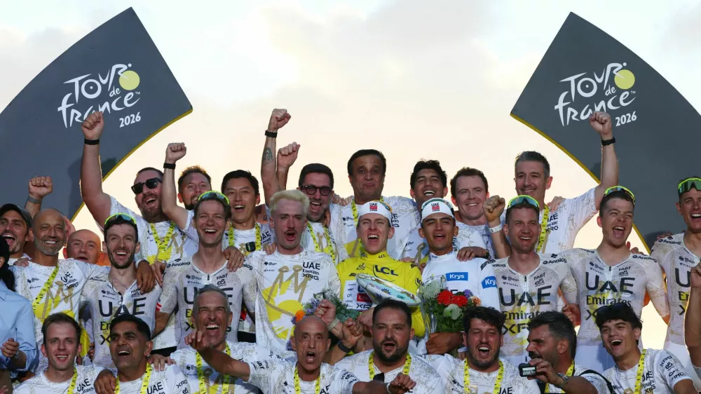Cycling - Tour de France - Stage 21 - Paris, France - July 26, 2026 UAE Team Emirates XRG's Tadej Pogacar celebrates on the podium while wearing the yellow jersey after winning the Tour de France, alongside UAE Team Emirates XRG's Isaac Del Toro wearing the white jersey and the UAE Team Emirates XRG team REUTERS/Gonzalo Fuentes