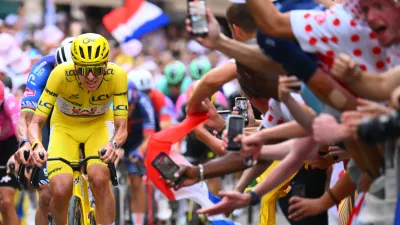 Slovenia's Tadej Pogacar, wearing the overall leader's yellow jersey, races through the cobbled streets of Montmartre during the last stage of the Tour de France cycling race with start and finish in Paris, Sunday, July 26, 2026. (AP Photo/Etienne Garnier/Pool Photo via AP)