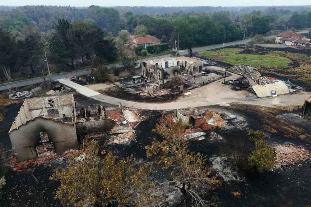 A drone view shows burnt buildings in an area affected by a wildfire, in Le Porge, Gironde, amid drought conditions following a heatwave and water shortages across much of France, July 27, 2026. REUTERS/Manon Cruz