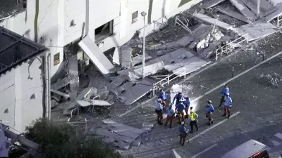 This aerial image shows rescue workers continue searching at the damaged AEON Mall after an earthquake in Kashima, Kumamoto prefecture, southern Japan, Tuesday, July 28, 2026. (Kyodo News via AP)