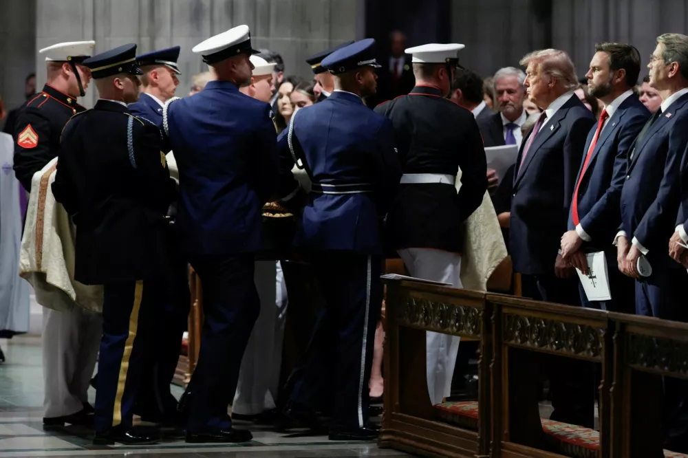 U.S. President Donald Trump looks on as the casket carrying the body of late U.S. Senator Lindsey Graham (R-SC) is carried out following a funeral service at Washington National Cathedral in Washington, D.C., U.S., July 28, 2026. REUTERS/Evan Vucci