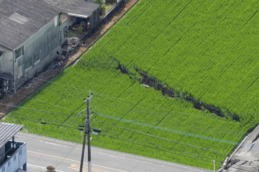 This aerial image shows a crack on the ground, a day after an earthquake, in Yatsushiro, Kumamoto Prefecture, on Wednesday, July 29, 2026. (Naoki Hiraoka/Kyodo News via AP)