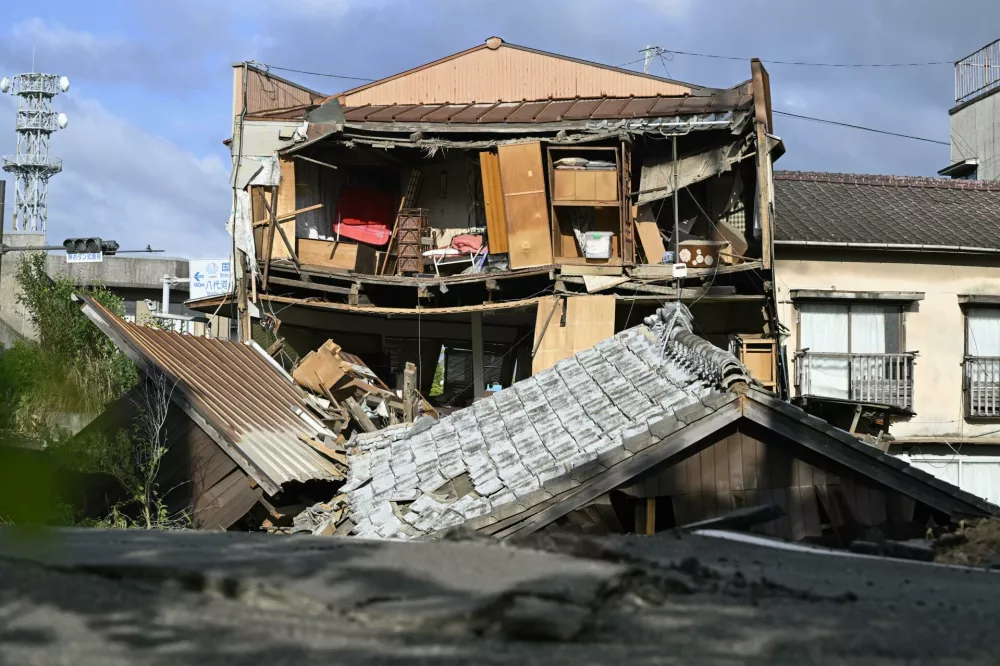 The roof and wall of a building are seen fallen, a day after an earthquake in Yatsushiro, Kumamoto prefecture, Wednesday, July 29, 2026.(Yu Nakajima/Kyodo News via AP)