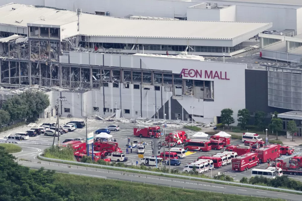 In this aerial image, emergency vehicles gather at AEON Mall, which was destroyed by an explosion following an earthquake, in Kashima, Kumamoto Prefecture, on Wednesday, July 29, 2026. (Naoki Hiraoka/Kyodo News via AP)