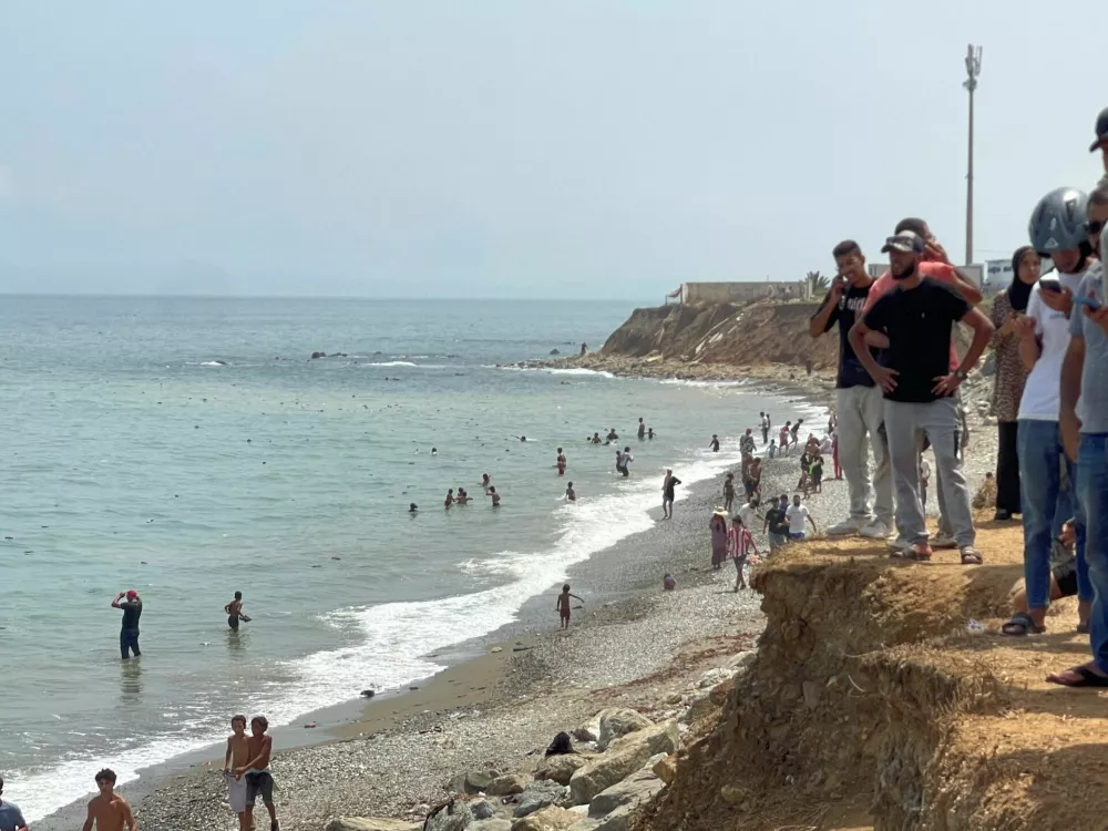 Migrants cross on foot into the North African enclave of Ceuta from Morocco by attemping to swim, according to Spain's Guardia Civil, near the border with Ceuta, in Fnideq, Morocco, July 30, 2026, in this still image obtained by REUTERS. THIS IMAGE HAS BEEN SUPPLIED BY A THIRD PARTY.  VERIFICATION: - Buildings, coastline and road layout matched satellite and archive imagery. - Coordinates: 35.85783579352456, -5.346942135788912. - Date verified by original file metadata.