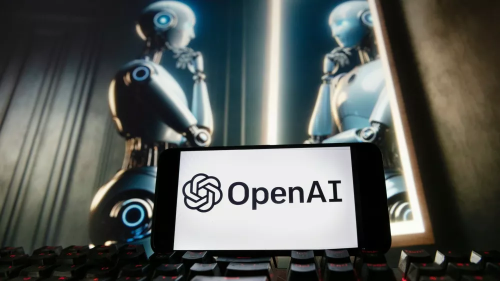 FILE - The OpenAI logo is displayed on a cellphone with an image on a computer monitor generated by ChatGPT's Dall-E text-to-image model, Dec. 8, 2023, in Boston. (AP Photo/Michael Dwyer, File)