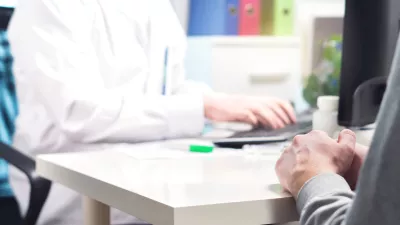 Doctor and patient in appointment, visit or meeting in hospital office or emergency room. Physician or nurse writing prescription, instructions, medical record or data with computer.