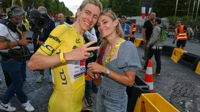 Slovenia's Tadej Pogacar, wearing the overall leader's yellow jersey, celebrates with his girlfriend Urska Zigart after the the last stage of the Tour de France cycling race in Paris, Sunday, July 26, 2026. (AP Photo/Dario Belingheri/Pool Photo via AP)