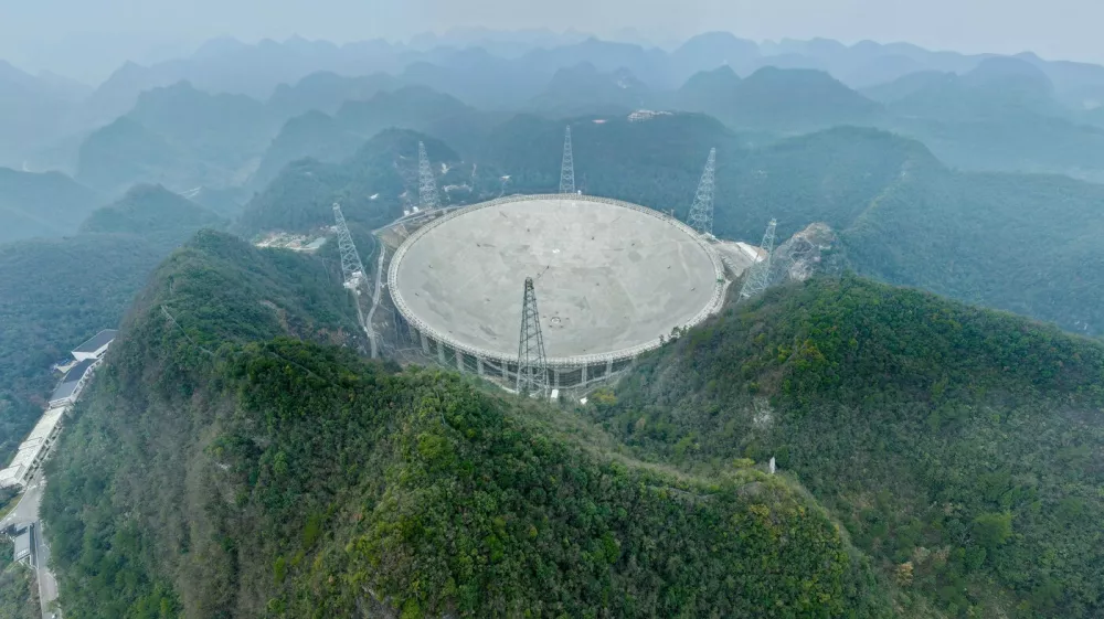 GUIYANG, Jan. 16, 2026 -- An aerial drone photo taken on Jan. 16, 2026 shows China's Five-hundred-meter Aperture Spherical Radio Telescope (FAST) under maintenance in southwest China's Guizhou Province. Through studying the observation data of China's gigantic radio telescope located in the country's southwestern Guizhou Province, an international research team has uncovered compelling new evidence supporting a binary-system origin for at least some fast radio bursts, one of the most enigmatic phenomena in modern astrophysics. These findings made by the research team, led by astronomers from the Purple Mountain Observatory of the Chinese Academy of Sciences, are based on observations using FAST, and have been published online in the journal Science.,Image: 1066473089, License: Rights-managed, Restrictions:, Model Release: no 